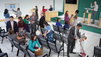 Brothers and sisters before a congregation meeting. 1. They greet and talk with one another. 2. A brother shows a sister something posted on the information board. 3. A sister places a donation in the contribution box. 4. A brother behind the counter hands literature to a sister. 5. A brother adjusts a microphone on the platform. 6. A brother and his young son clean.