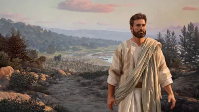 Jesus walking alone up a mountain path. A large group of people are gathered at the base of the mountain.