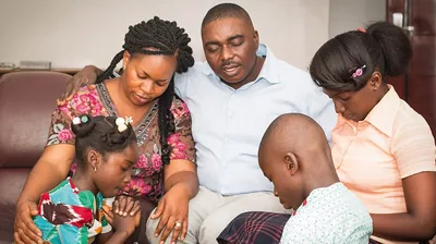 A father prays with his family