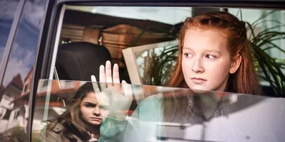 A young woman is sad to see her friend move away