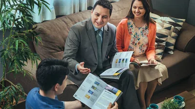 A brother, accompanied by his wife, conducts a Bible study with a young man who has a printed copy of the Enjoy Life Forever! book (See paragraph 2)