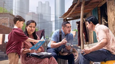 A couple witnessing to a man and his young son who live in a shanty near luxury high-rise apartment buildings.