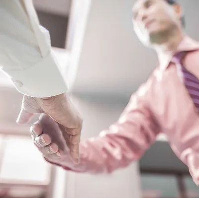 Two Christian brothers shake hands