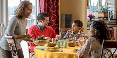 A family enjoys a conversation at mealtime