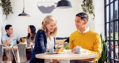 A couple happily chatting together in a café.