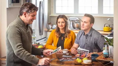 A couple visiting a brother whose wife has died. They share photos of happy moments they spent with her.