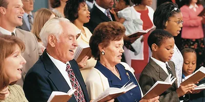 Brothers and sisters singing at a congregation meeting.