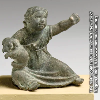 A Greek or Roman statuette of a child with a puppy
