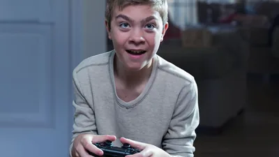 A boy intensely playing a video game.